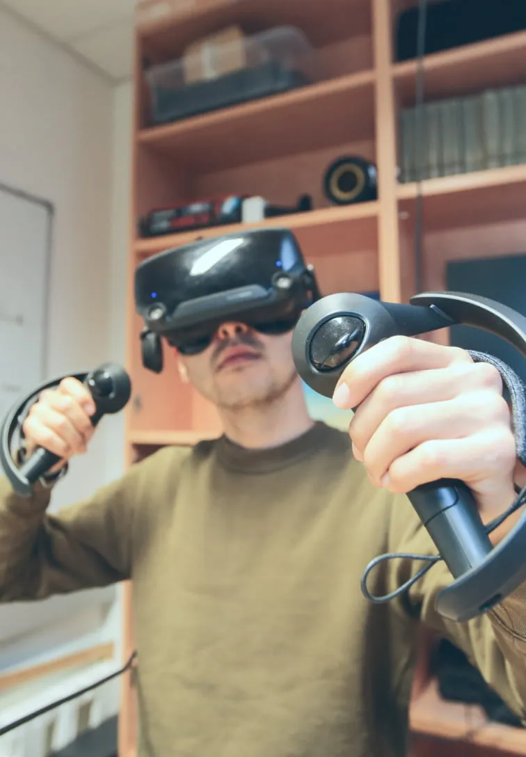 A man wearing Valve Index VR Headset in an office space